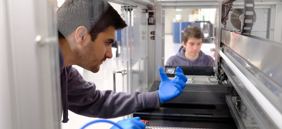 Daniel Nakhaee-Zadeh (COO) inspecting microfluidic chip to test thousands of AI-generated proteins.JPG
